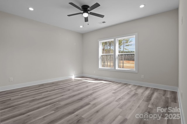 empty room featuring baseboards, visible vents, a ceiling fan, wood finished floors, and recessed lighting