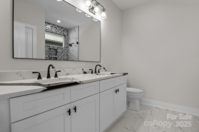 full bathroom featuring marble finish floor, a sink, baseboards, and toilet