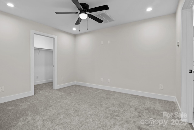 unfurnished bedroom with a spacious closet, carpet, visible vents, and recessed lighting