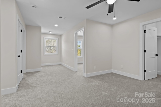 carpeted empty room featuring baseboards, visible vents, a ceiling fan, and recessed lighting