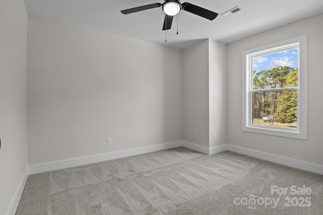 empty room featuring carpet floors, baseboards, and visible vents