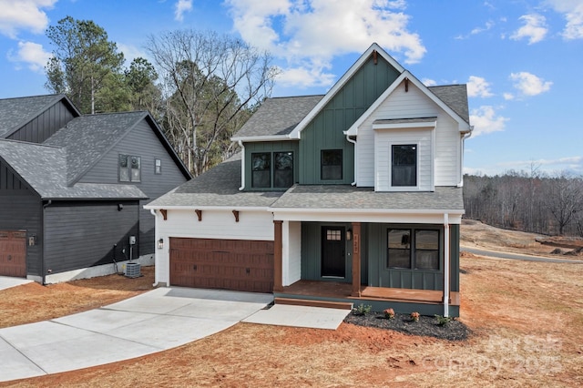 modern farmhouse featuring roof with shingles, covered porch, concrete driveway, an attached garage, and board and batten siding