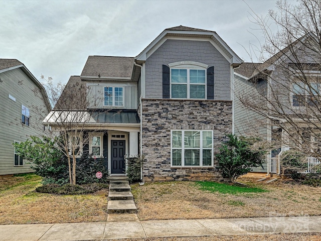 view of front of home featuring a standing seam roof, stone siding, and metal roof