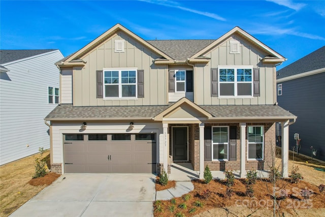 craftsman-style house with brick siding, roof with shingles, concrete driveway, board and batten siding, and a garage