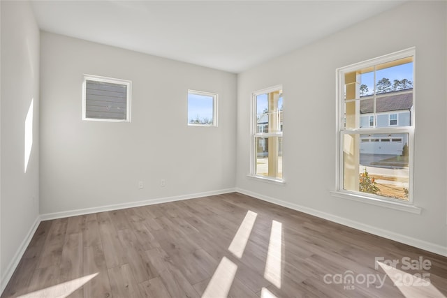 unfurnished room featuring wood finished floors and baseboards