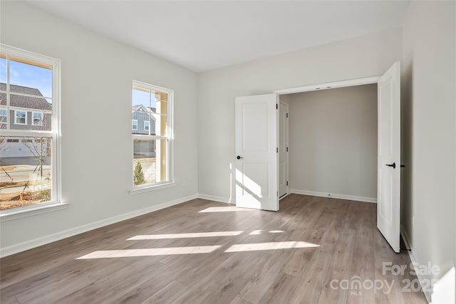 unfurnished bedroom featuring baseboards and wood finished floors