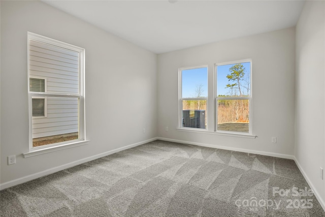 carpeted empty room with baseboards