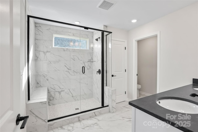 full bathroom featuring toilet, a sink, visible vents, marble finish floor, and a marble finish shower