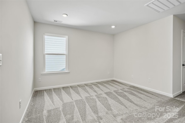 carpeted empty room featuring visible vents and baseboards