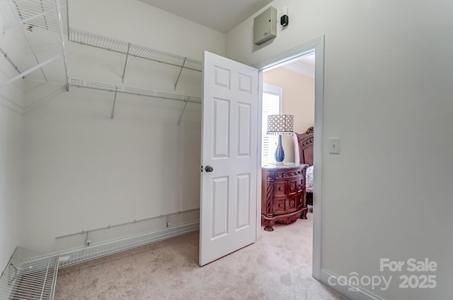 walk in closet featuring carpet