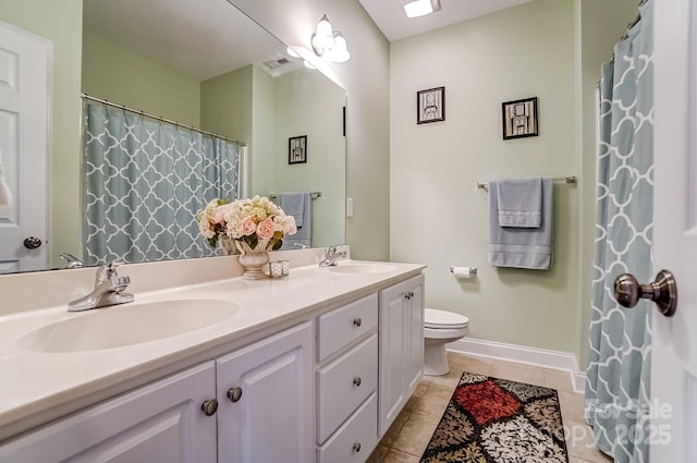 full bath featuring double vanity, tile patterned flooring, a sink, and toilet