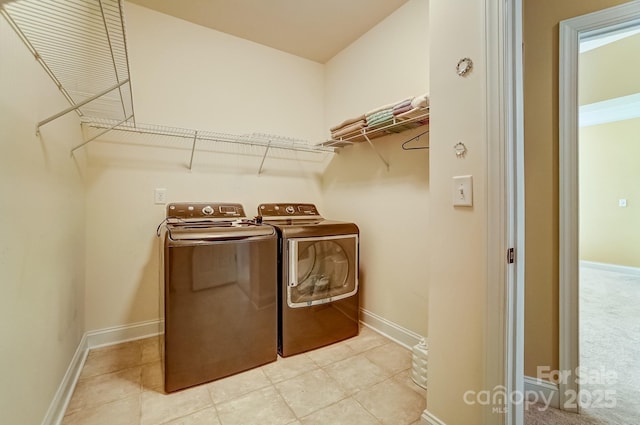 washroom with washer and dryer, laundry area, and baseboards