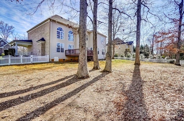 exterior space with crawl space, fence, and a deck