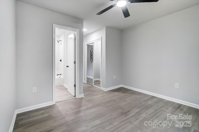 interior space with a closet, wood finished floors, and baseboards