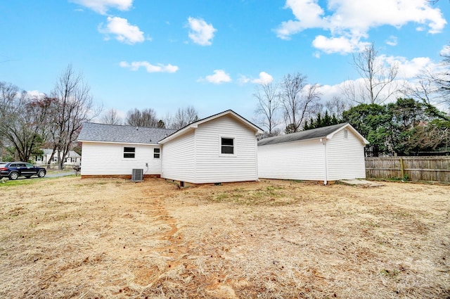 back of property featuring fence and central AC unit