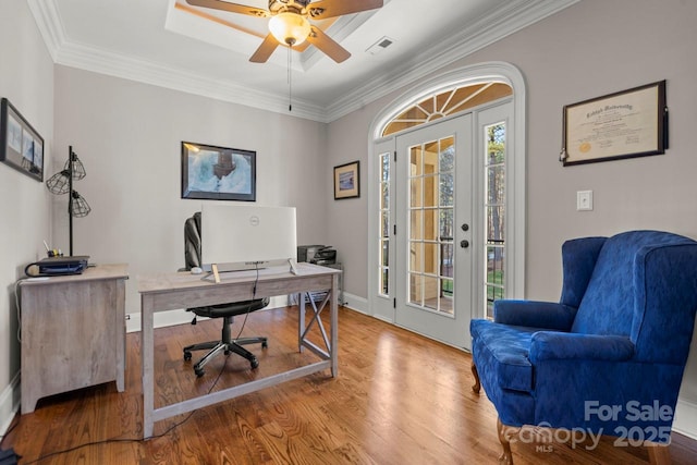 office area with ceiling fan, wood finished floors, visible vents, and crown molding