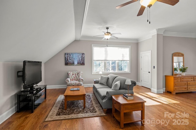 living room with lofted ceiling, ornamental molding, wood finished floors, and baseboards