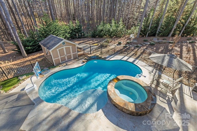 view of pool featuring a storage shed, a pool with connected hot tub, a fenced backyard, and an outdoor structure