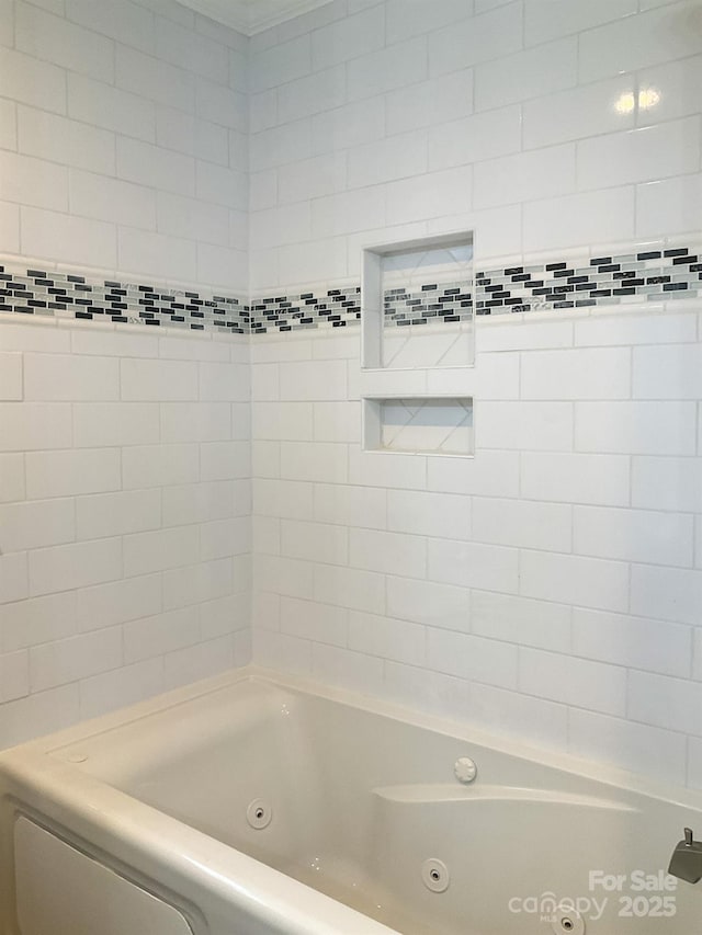 bathroom with a combined bath / shower with jetted tub