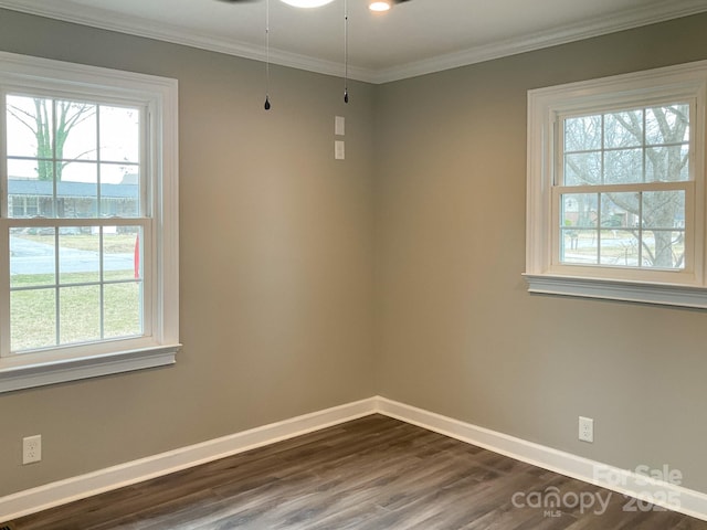 unfurnished room with ornamental molding, a healthy amount of sunlight, dark wood finished floors, and baseboards