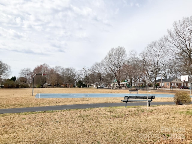 view of property's community featuring playground community, a yard, and community basketball court