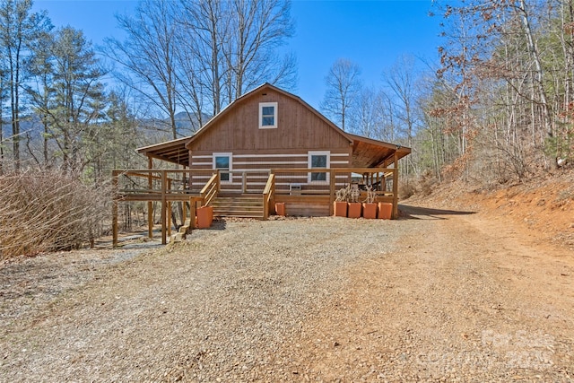 back of property with an outdoor structure