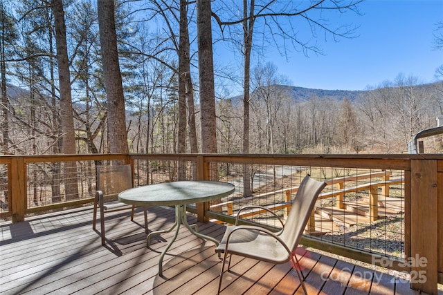 wooden deck featuring a forest view