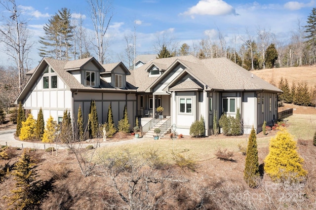 view of front of home featuring board and batten siding and a shingled roof