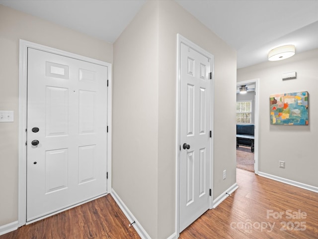 hall with wood finished floors and baseboards