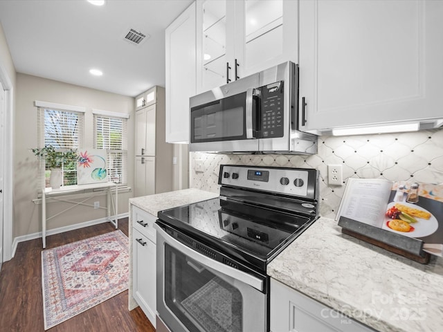 kitchen with dark wood-style floors, visible vents, white cabinetry, and stainless steel appliances