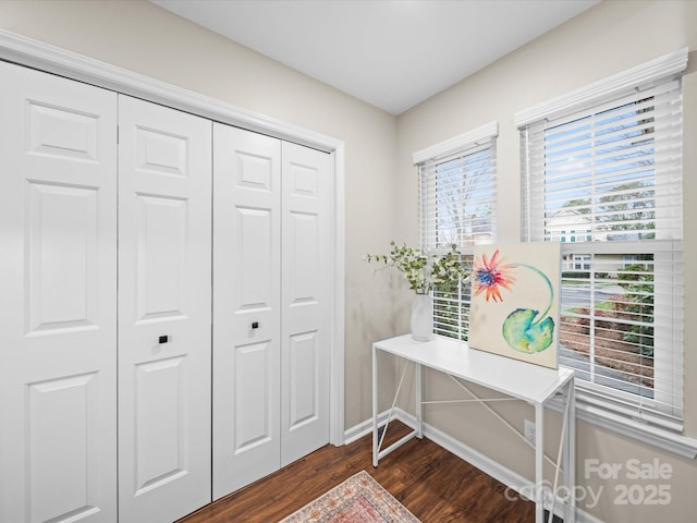 foyer entrance with baseboards and dark wood finished floors