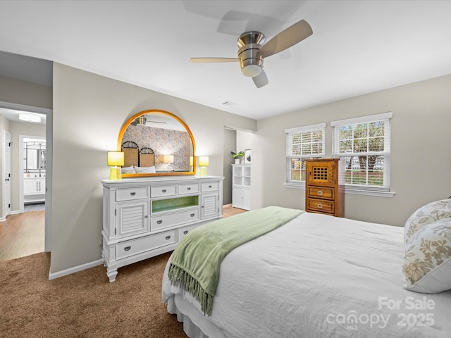 carpeted bedroom featuring visible vents, ceiling fan, and baseboards