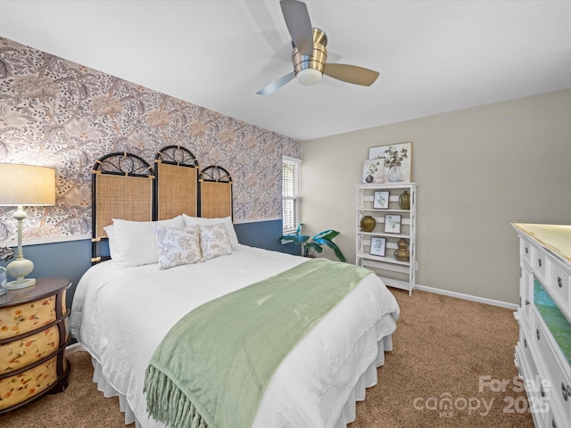 carpeted bedroom with wallpapered walls, baseboards, and a ceiling fan