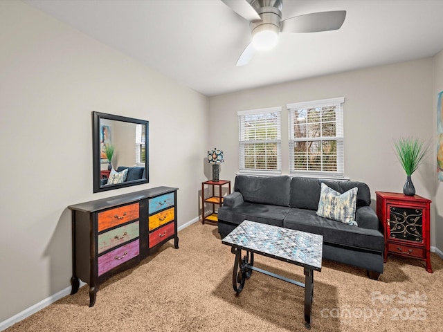 living room featuring carpet flooring, a ceiling fan, and baseboards