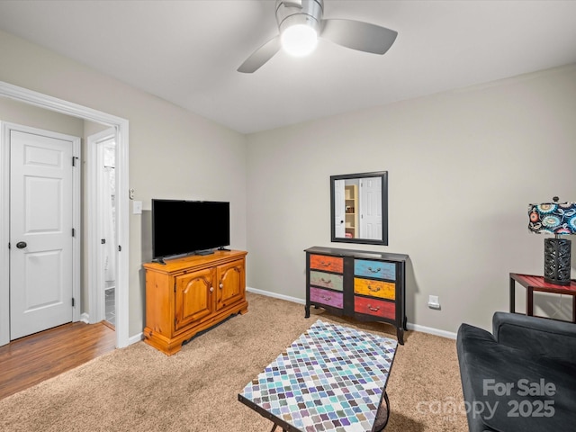 sitting room with carpet flooring, a ceiling fan, and baseboards