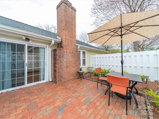 view of patio / terrace featuring outdoor dining area and fence