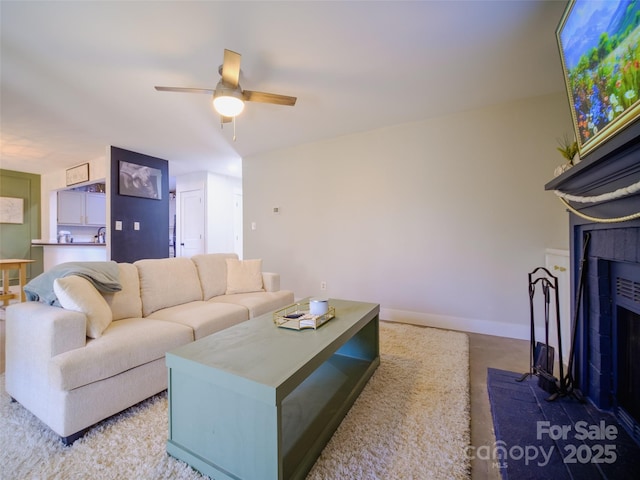 living room featuring ceiling fan and baseboards