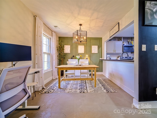 office space with a chandelier, concrete floors, visible vents, and baseboards