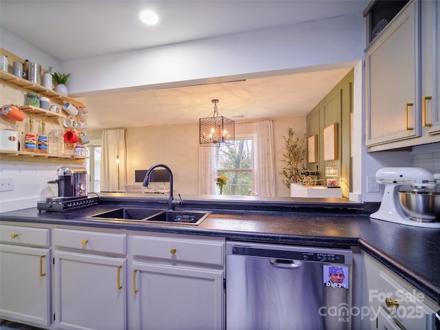 kitchen with dishwasher, dark countertops, decorative light fixtures, white cabinetry, and a sink