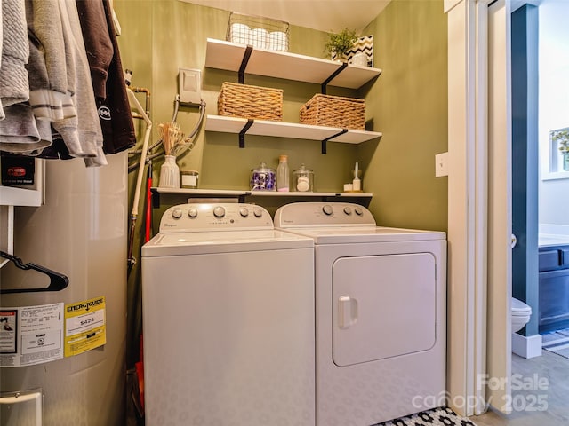 laundry room with washing machine and dryer, laundry area, and water heater