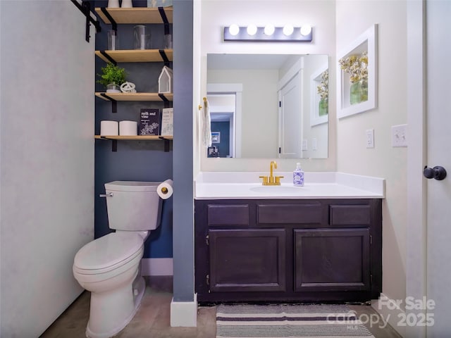 half bath with vanity, toilet, and baseboards