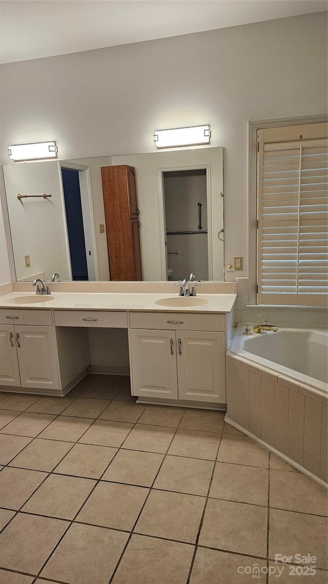 full bath with a garden tub, vanity, and tile patterned floors