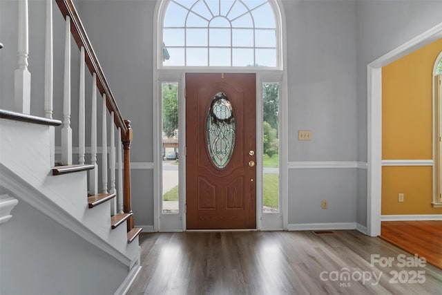 8731 Sheltonham Way, Charlotte, NC 28216 - entrance foyer featuring wood finished floors, stairway, and a towering ceiling