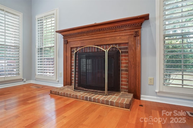 8731 Sheltonham Way, Charlotte, NC 28216 - detailed view of wood finished floors and a brick fireplace