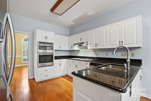 8731 Sheltonham Way, Charlotte, NC 28216 - kitchen featuring appliances with stainless steel finishes, under cabinet range hood, and white cabinets