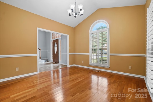 8731 Sheltonham Way, Charlotte, NC 28216 - unfurnished room featuring a chandelier, wood finished floors, and vaulted ceiling