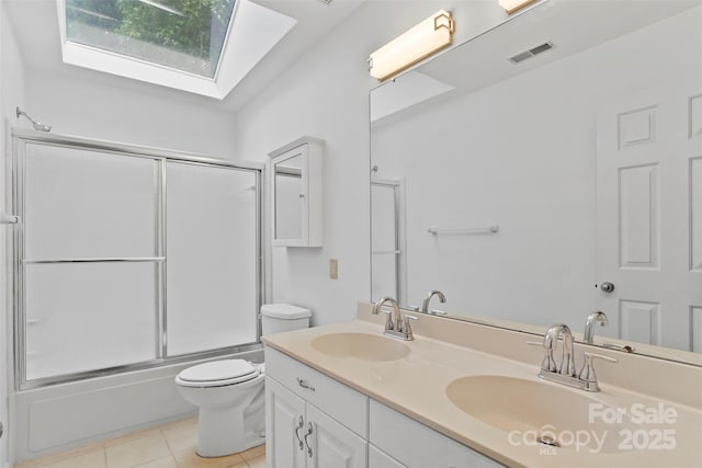 8731 Sheltonham Way, Charlotte, NC 28216 - bathroom with a skylight, double vanity, combined bath / shower with glass door, and tile patterned floors