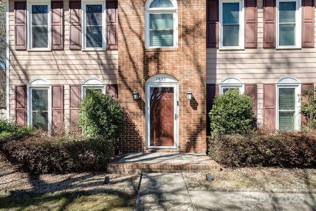 property entrance with brick siding