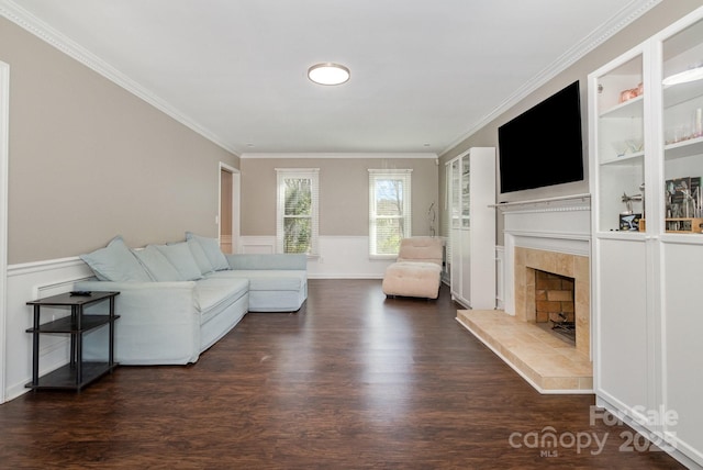 unfurnished living room with built in shelves, a tile fireplace, crown molding, and wood finished floors