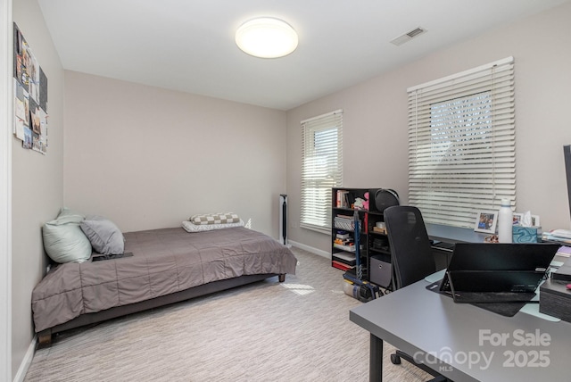 carpeted bedroom featuring visible vents and baseboards